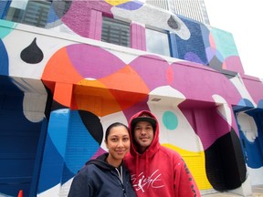 Rust Magic organizers Annaliza Toledo and Trevor Peters, in front of their mural on the Vignettes Building at 10004 103A Ave.