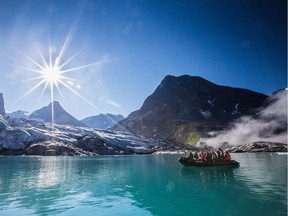 A previous Students on Ice expedition explores a glacier from a small Zodiac boat off the coast of Kangerlussuaq, Greenland.