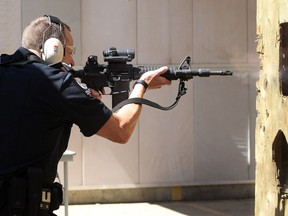 Const. Travis Eltom demonstrates the use of a C8 Carbine at the William Nixon range in 2014.