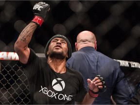 Flyweight champion Demetrious Johnson (left) celebrates after beating Ali Bagautinov (right) and remaining champion during UFC 174 flyweight title match bout at Rogers Arena in Vancouver, B.C. on Saturday June 14, 2014.