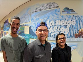 Artists AJA Louden, Clay Lowe and Matthew Auger Cardinal at their mural This City in Edmonton City Centre.