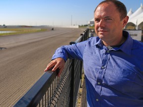 Paul Ryneveld, General Manager at Century Downs Racetrack and Casino looks out on the track as horses train on Thursday morning July  27, 2017. Gavin Young/Postmedia