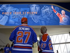 Patrick Bohnet (left) and Vera Buzak pay their respects at Ford Hall in Rogers Place where a celebration of life for former Edmonton Oiler Dave Semenko was held on July 6, 2017. Semenko died of cancer at the age of 59.