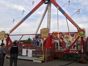 Authorities stand near the Fire Ball amusement ride at the Ohio State Fair after it malfunctioned, killing one person and injuring several others on Wednesday, July 26, 2017, in Columbus, Ohio.