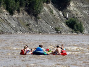 Groups of tubers tubing down the Pembina River.