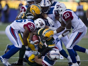 Edmonton Eskimos Travon Van (5) is tackled by the Montreal Alouettes during first half CFL action on Friday June 30, 2017, in Edmonton.