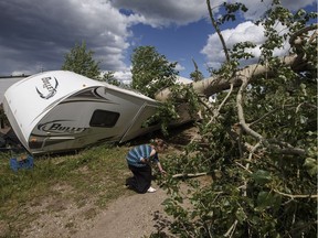 Residents clean up after a storm ripped through the city, in Red Deer, Alta., on Wednesday, June 21, 2017. Hail and wind gusts of 110 km/h pummelled the the city.