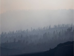 Smoke drifting over the Rockies hung in the air over Edmonton Monday but Environment Canada says there is no concerns yet over air quality. Above, smoke from fills the air on the side of a mountain in Boston Flats, B.C., on Sunday.