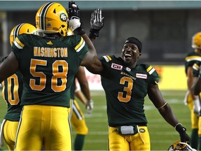 Edmonton Eskimos Natey Adjei (3) and  Tony Washington (58) celebrate defeating the Ottawa Redblacks 23 - 21during CFL action at Commonwealth Stadium in Edmonton, July 14, 2017. The Eskimos released Washington on Monday.