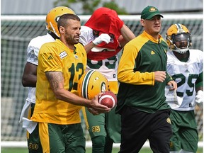 Edmonton Eskimos quarterback Mike Reilly jogging with head coach Jason Maas during practice at Clarke Stadium in Edmonton, August 14, 2017.