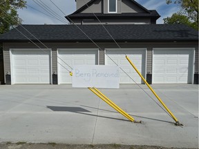 This four car garage attached to an infill fourplex, has guy wires mounted in the middle of the driveway on 105 Avenue near 150 Street in Edmonton, August 25, 2017.