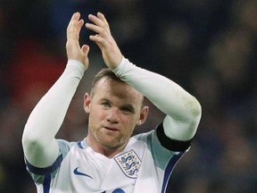 FILE - This is a Friday, Nov. 11, 2016 file photo of England&#039;s Wayne Rooney as he claps after winning the World Cup group F qualifying soccer match between England and Scotland with a 3-0 score at the Wembley stadium, London. England striker Wayne Rooney announced his immediate retirement from international football on Wednesday Aug. 23, 2017. (AP Photo/Matt Dunham/File)