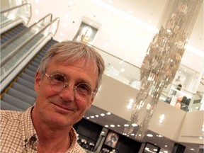 Peter von Tiesenhausen and his suspended artwork, Drawn by Desire, made of 500 individual plates which look like a human figure from a specific angle.