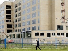 A pedestrian makes their way past the former Charles Camsell Hospital, 12815  115 Ave., in Edmonton Wednesday June 28, 2017.