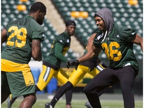 Mercy Maston, left, and Arjen Colquhoun take part in an Edmonton Eskimos team practice at Commonwealth Stadium, in Edmonton Wednesday Aug. 2, 2017.