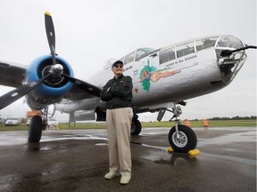 Retired B-25 pilot Gerry Regehr poses for a photo with a Second World War B-25J Mitchell bomber at the Villeneuve Airport, west of Edmonton, on Friday Aug. 4, 2017.