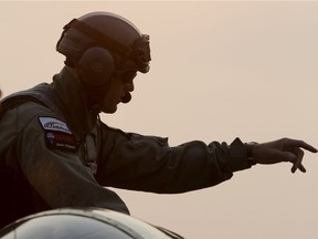 Geoff Latter climbs into his Nanchang CJ-6A while flying at the Villeneuve Airport prior to the start of the Edmonton Airshow, Friday Aug. 18, 2017.