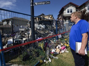 Cordell Brown looks at what is left of his home at 1040 Armitage Cres. SW in Edmonton, Friday Aug. 25, 2017. Brown's five-month-old son died in hospital after fire crews pulled the baby and his mom, Angie Tang, from the second floor of the burning home around 4 a.m. last Tuesday.
