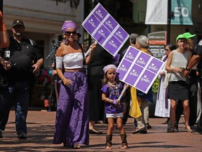 Supporters gather on the pedestrian mall outside the Paramount Theater during a memorial service for Heather Heyer on Aug. 16, 2017 in Charlottesville, Va. The memorial service was held four days after Heyer was killed when a participant in a white nationalist, neo-Nazi rally allegedly drove his car into the crowd of people demonstrating against the 'alt-right' gathering.