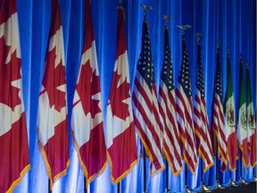 The flags of Canada, the United States, and Mexico, line the stage before the start of the negotiations for the modernization of NAFTA on Aug. 16, 2017, in Washington, D.C.