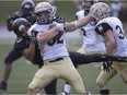 AKO's Ishmael Johnson takes down Edmonton's Jimmie Airey during the season opener between the AKO Fratmen and the Edmonton Huskies at Alumni Field, Saturday, August 12, 2017.