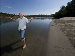 Cloverdale resident Paul Bunner gestures while standing on the massive beach that has popped up on the banks of the North Saskatchewan River this year, on Thursday, Aug. 17, 2017.