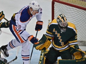 Edmonton Oilers rookie Jesse Puljujarvi (39) in front of University of Alberta Golden Bears goalie Kenny Cameron (31) at Clare Drake Arena in Edmonton Sept. 21, 2016.