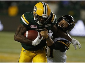 Edmonton Eskimos Chris Edwards (26) breaks away from Hamilton Tiger-Cats Sergio Castillo (41) during second half CFL action on Friday August 4, 2017, in Edmonton.