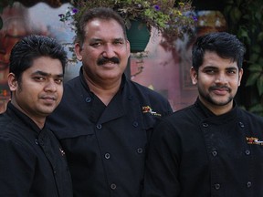 Parkash Chhibber (centre) stands with members of his staff Purvak Patel (left) and Abhishek Gaekwad (right) outside his restaurant, Indian Fusion - The Curry House at 10322 111 St. in Edmonton, Alta. on Saturday, Aug. 19, 2017. Chhibber began offering free meals to those in need out of the back of his restaurant three years ago, the same food he serves to his paying customers, and now serves as many as 1,600 hot meals to those in need every month.