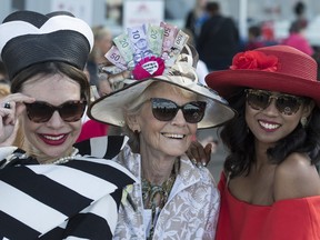 (from left) Laura Dreger won first prize, Elizabeth Graham won third and Robi Adawiya took second with their stylish hats at the 88th running of the Canadian Derby at Northlands park in Edmonton on Saturday Aug. 19, 2017.
