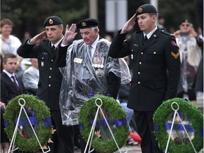 Veteran Stan Edwards, centre, lays a wreath on behalf of veterans during a ceremony in honour of the 75th anniversary of the Dieppe Raid, at the National War Memorial in Ottawa on Tuesday, Aug. 22, 2017. THE CANADIAN PRESS/Justin Tang