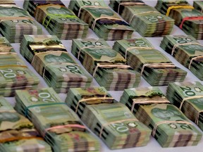 The Edmonton Police Service displays cash and drugs at police headquarters on Aug. 11, 2017 that were seized from three men who were charged with drug trafficking.