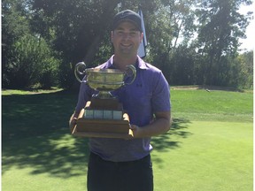 Ryan DenBraber holds the trophy after winning the Subaru City Edmonton Amateur golf championship at the Edmonton Country Club on Monday, Aug. 28, 2017.