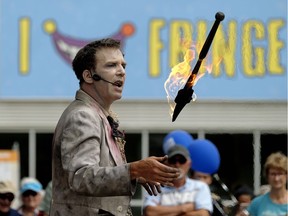 Chris, from the street busking duo Undead Newlyweds, juggles flaming knives at the 2017 Edmonton International Fringe Theatre Festival in on Aug. 21, 2017.