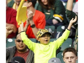 An Edmonton fan cheers during a CFL game between the Edmonton Eskimos and the Ottawa Redblacks at The Brick Field at Commonwealth Stadium in Edmonton on Saturday, June 25, 2016.