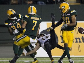 Edmonton Eskimos Garry Peters (34) Josh Woodman (7) and Johnny Adams (20) stop a final attempt by the Hamilton Tiger-Cats Mike Jones (12) to win the game on Friday August 4, 2017, in Edmonton.