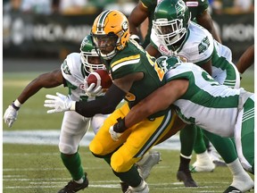 Edmonton Eskimos Pascal Lochard (25) about to be tackle by Saskatchewan Roughriders during CFL action at Commonwealth Stadium in Edmonton, August 25, 2017.