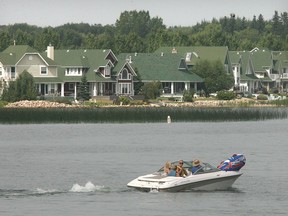A boat cruises past homes on the shore of Sylvan Lake. File photo.