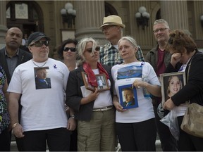 Families who have lost loved ones gather in front of the legislature with photos of their loved ones on International Overdose Awareness Day, Thursday, Aug. 31, 2017.