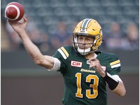 Edmonton Eskimos quarterback Mike Reilly (13) makes the throw against the Hamilton Tiger-Cats during first half CFL action in Edmonton, Alta., on Friday August 4, 2017.