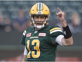 Edmonton Eskimos quarterback Mike Reilly (13) calls a play against the Hamilton Tiger-Cats during first half CFL action in Edmonton on Aug. 4, 2017.