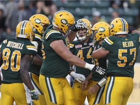 Edmonton Eskimos offensive lineman David Beard, right, celebrates a touchdown with teammates against the Hamilton Tiger-Cats during first half CFL action in Edmonton, Alta., on Friday August 4, 2017.