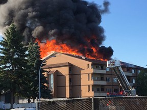 Firefighters battle a blaze in a four-storey apartment building at 14808 26 Street around 6:30 p.m. Friday, Aug. 11, 2017. It appeared that large sections of the roof were damaged.