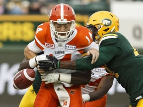 Edmonton's Kwaku Boateng (93) and Odell Willis (41) sack BC quarterback Travis Lulay during a CFL game between the Edmonton Eskimos and the BC Lions at Commonwealth Stadium in Edmonton on Friday, July 28, 2017.