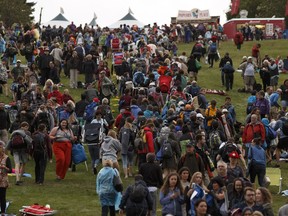 Attendees evacuate after a storm warning forced the Edmonton Folk Music Festival to close at Gallagher Park in Edmonton on Thursday, August 10, 2017.