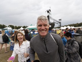 A happy man asked the photographer to take his photo as his family evacuated due to a storm from the Edmonton Folk Music Festival to close at Gallagher Park in Edmonton on Thursday, August 10, 2017.