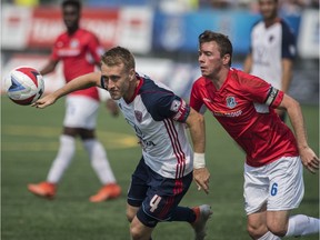 Nik Ledgerwood of FC Edmonton, right, chases midfielder Brad Ring of the Indy Eleven at Clarke Stadium kicking off the fall NASL season in Edmonton on July 29, 2017.