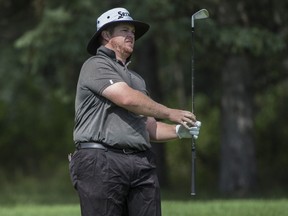 Patrick Newcomb watches his second shot on the first hole before play was suspended. Lightning in the area forced the delay of the third round of the Syncrude Oil Country Golf Championship at the Windermere Gold Club on August 5, 2017.