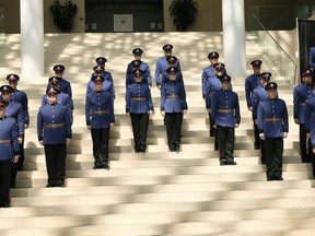 Recruit graduates stand at attention at the Edmonton Police Service graduation ceremony for recruit training class #138 at city hall on Friday Aug. 11, 2017.