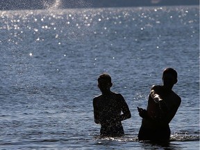 Boys play in the water at Ma-me-o Beach, a summer village located on the southeast shore of Pigeon Lake, Alta., which is approximately 100 km southwest of Edmonton. Alberta Health Services has issued an advisory about blue-green algae in Pigeon Lake.